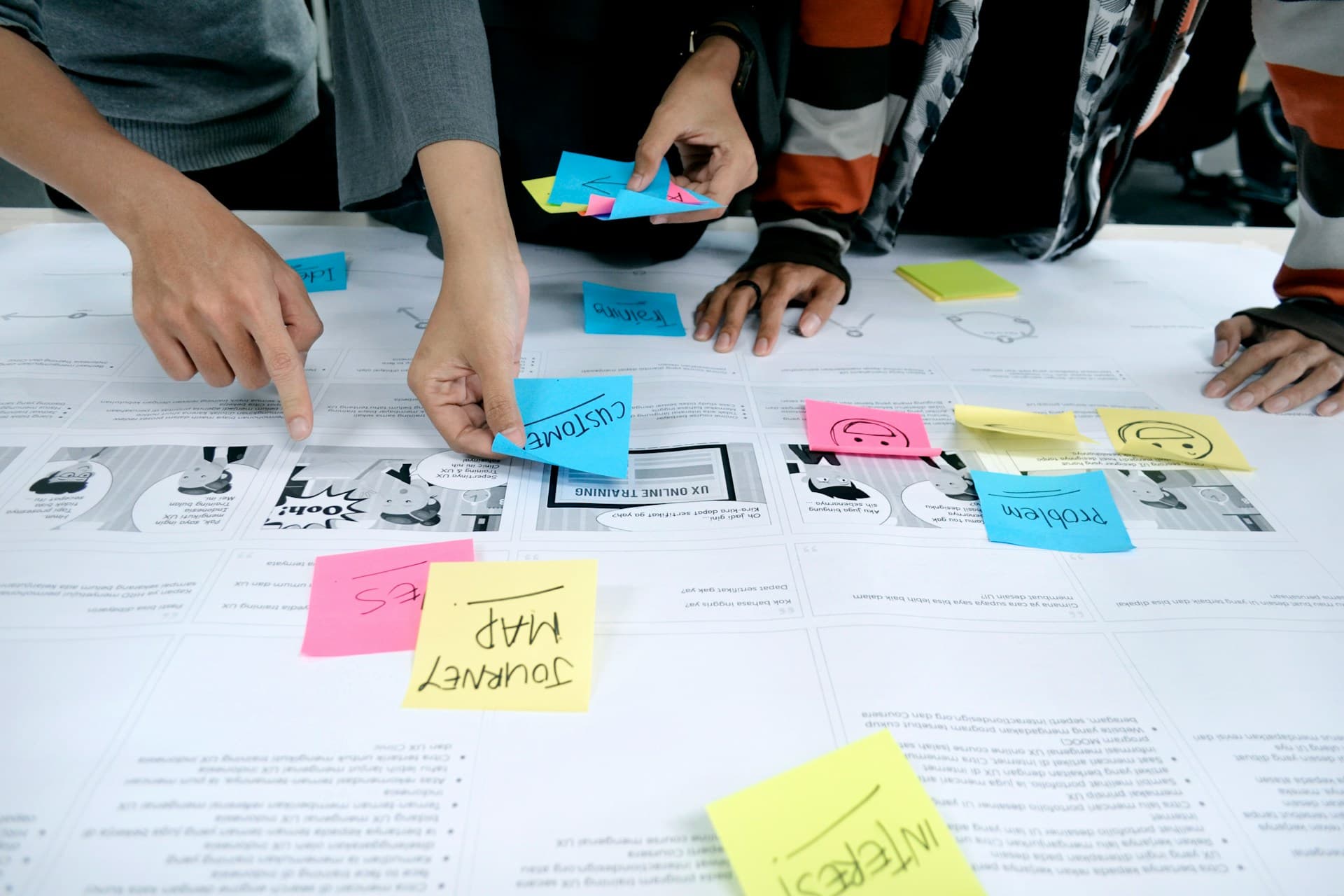 Business professionals collaborating around technology in a modern office